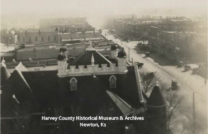 Bird's Eye view of Newton from the Courthouse Tower, ca. 1930. Roofline of the 1st Presbyterian Church and looking south down Main, Newton, Ks.